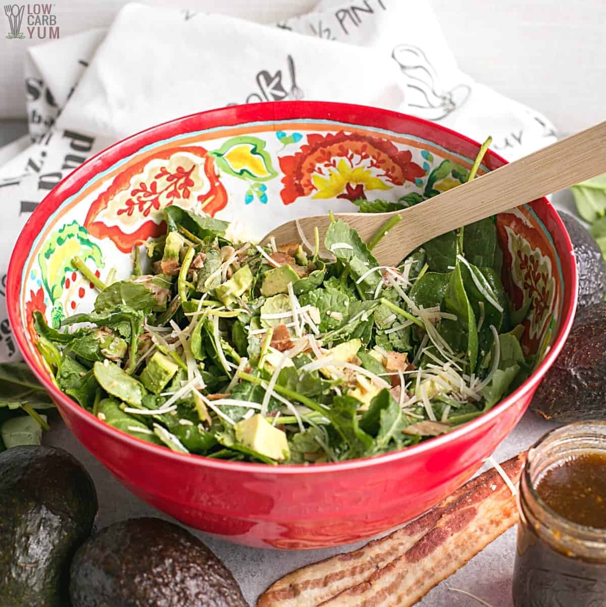 baby kale avocado salad mixed in large bowl
