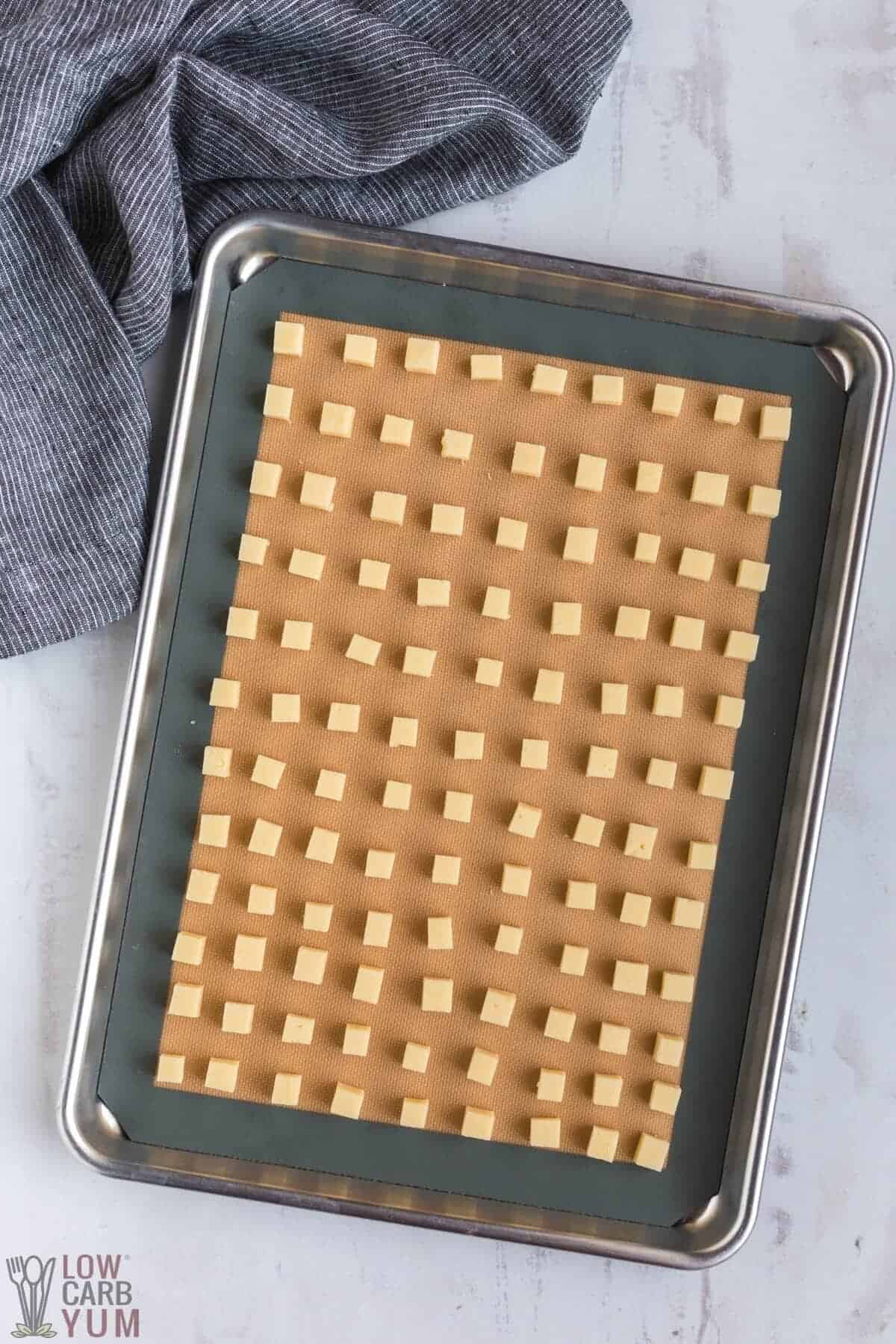 cubed cheese on lined baking sheet pan