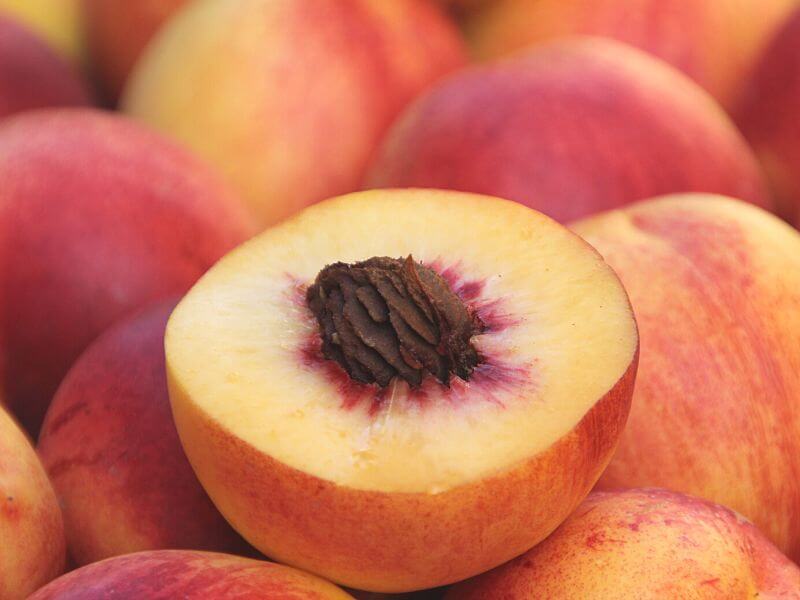 sliced peach with a pit inside.