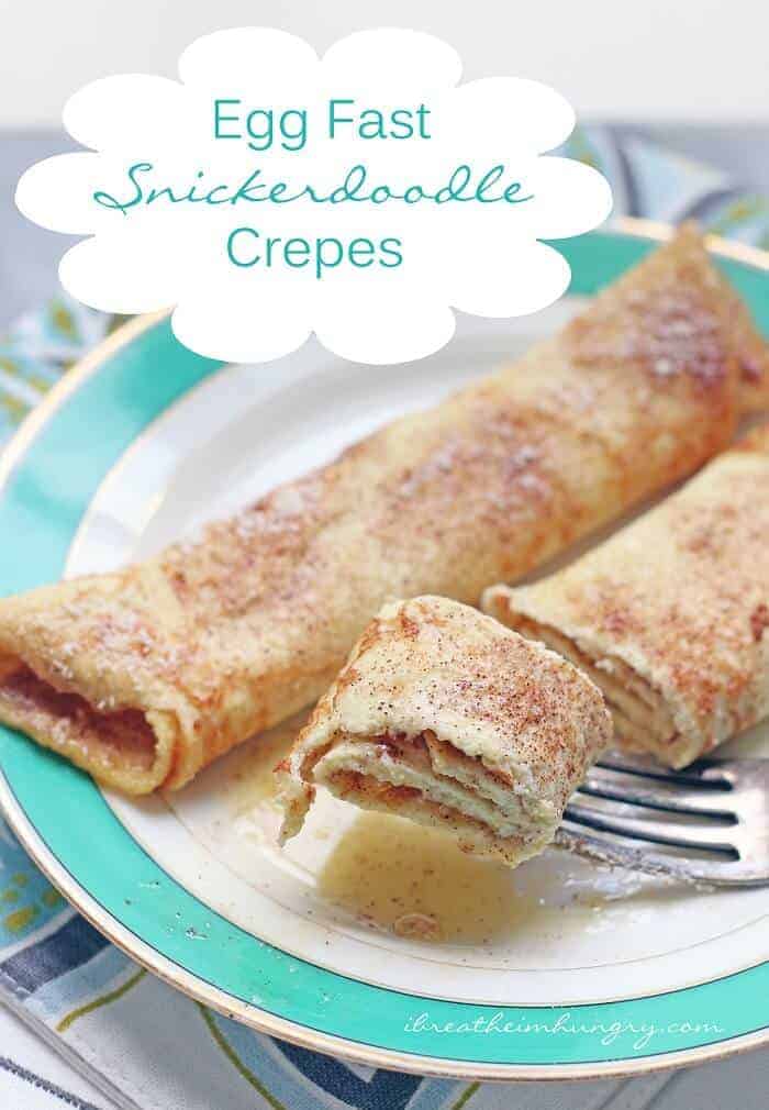 keto Snickerdoodle Crepes on plate with fork holding bite of crepes