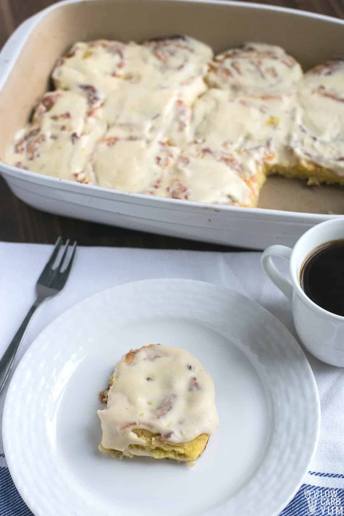 pinterest image of cinnamon rolls in casserole pan and on white plate with coffee