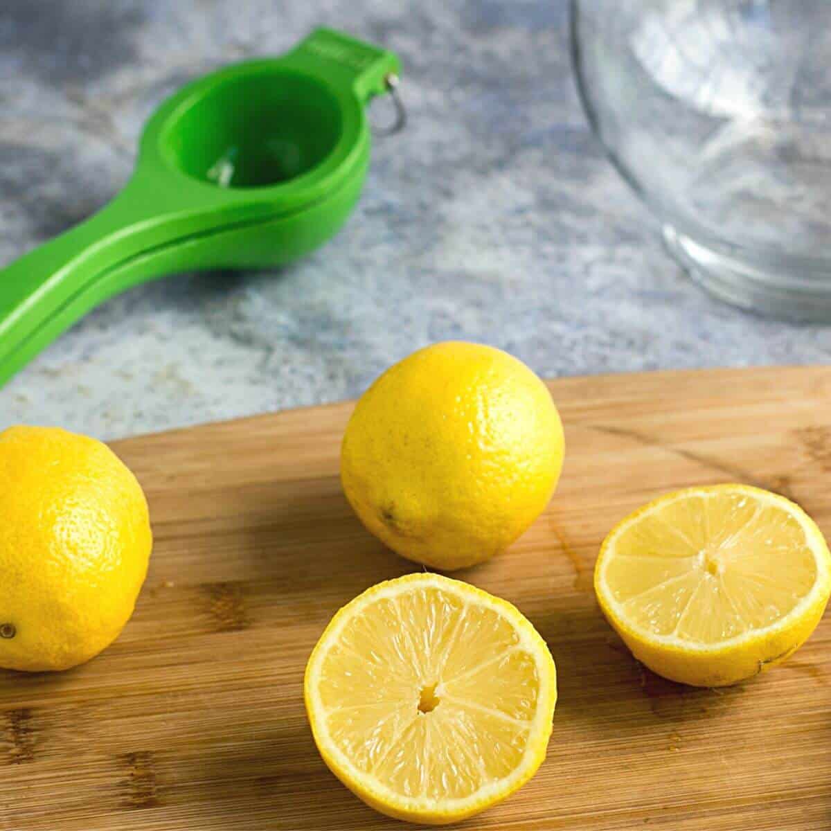lemons sliced on board with juicer.
