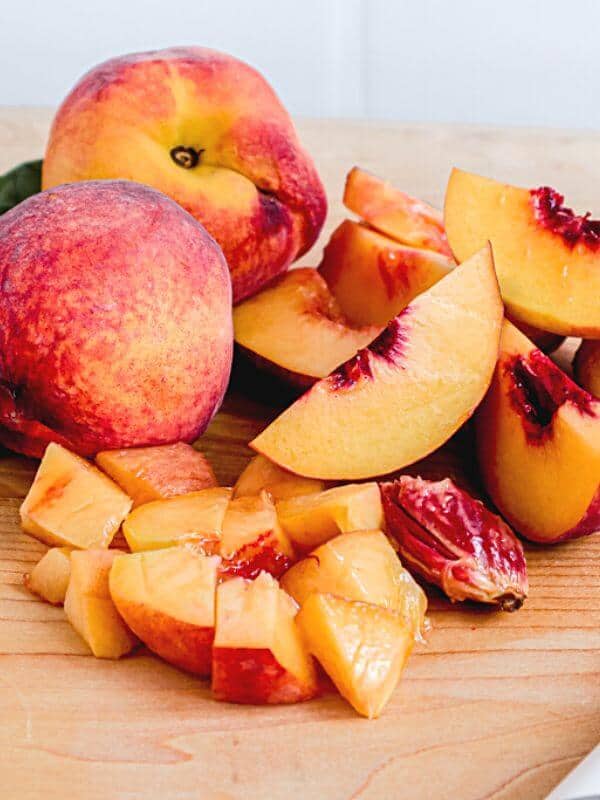 peaches cut into slices on cutting board.